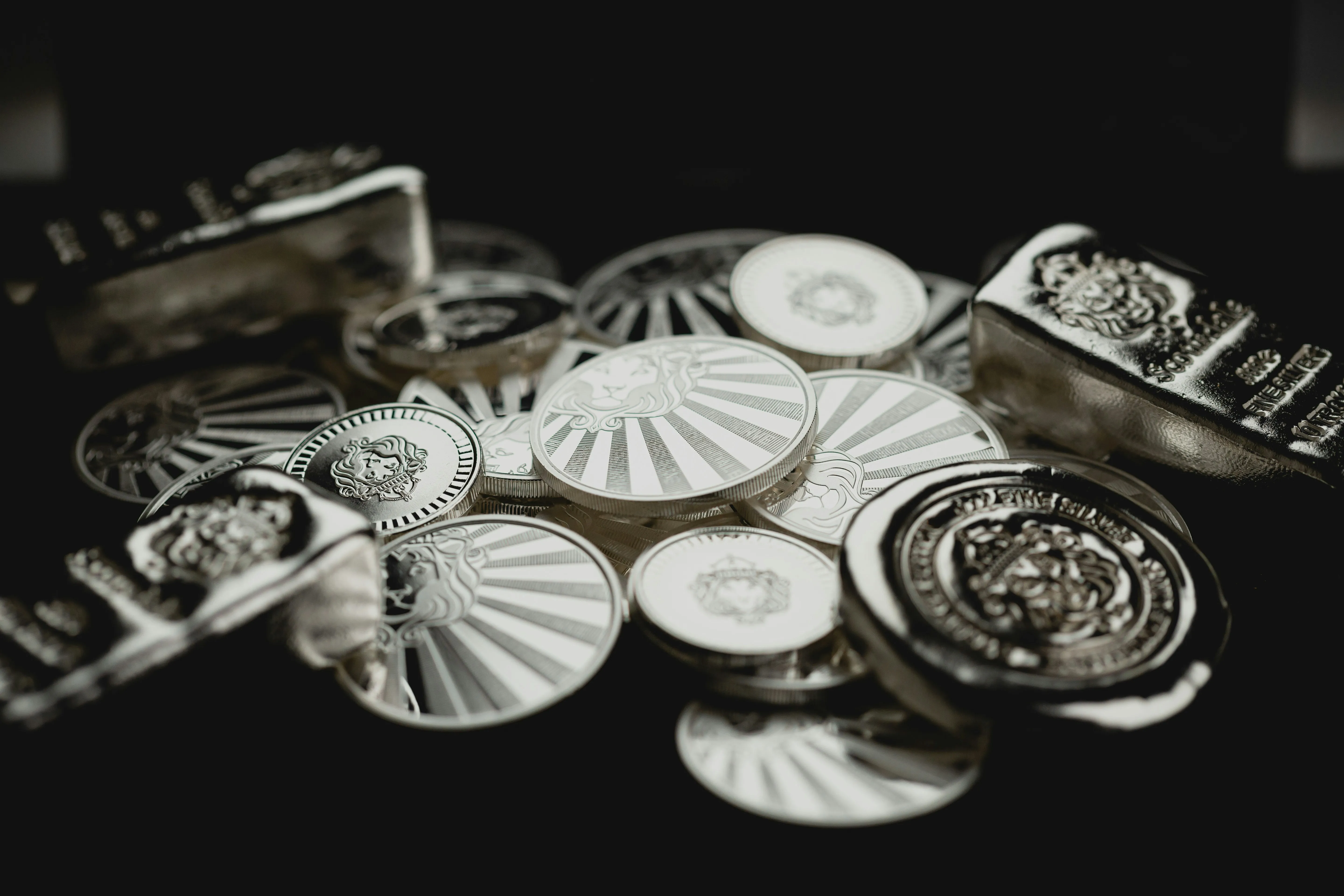Silver coins arranged on a dark surface